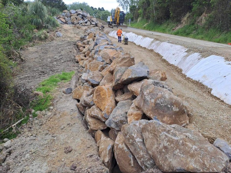 Image showing road workers and machinery repairing a slip on Whakapirau Road